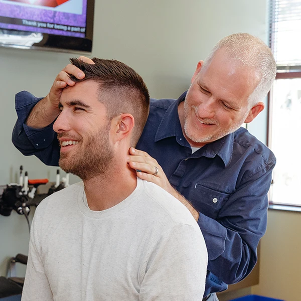 Chiropractor Victoria BC Brad Gage Examining Patient Neck