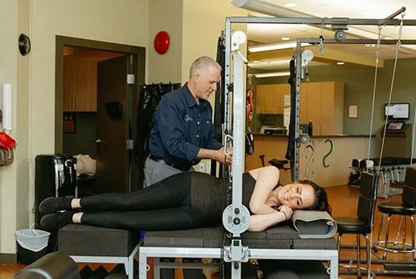 Chiropractor Victoria BC Dr. Brad Gage And Patient Scoliosis Machine